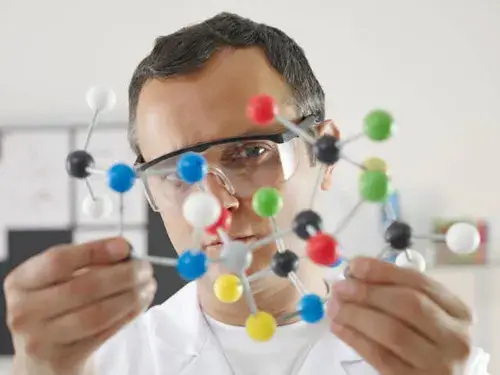 scientist holding molecule model 1